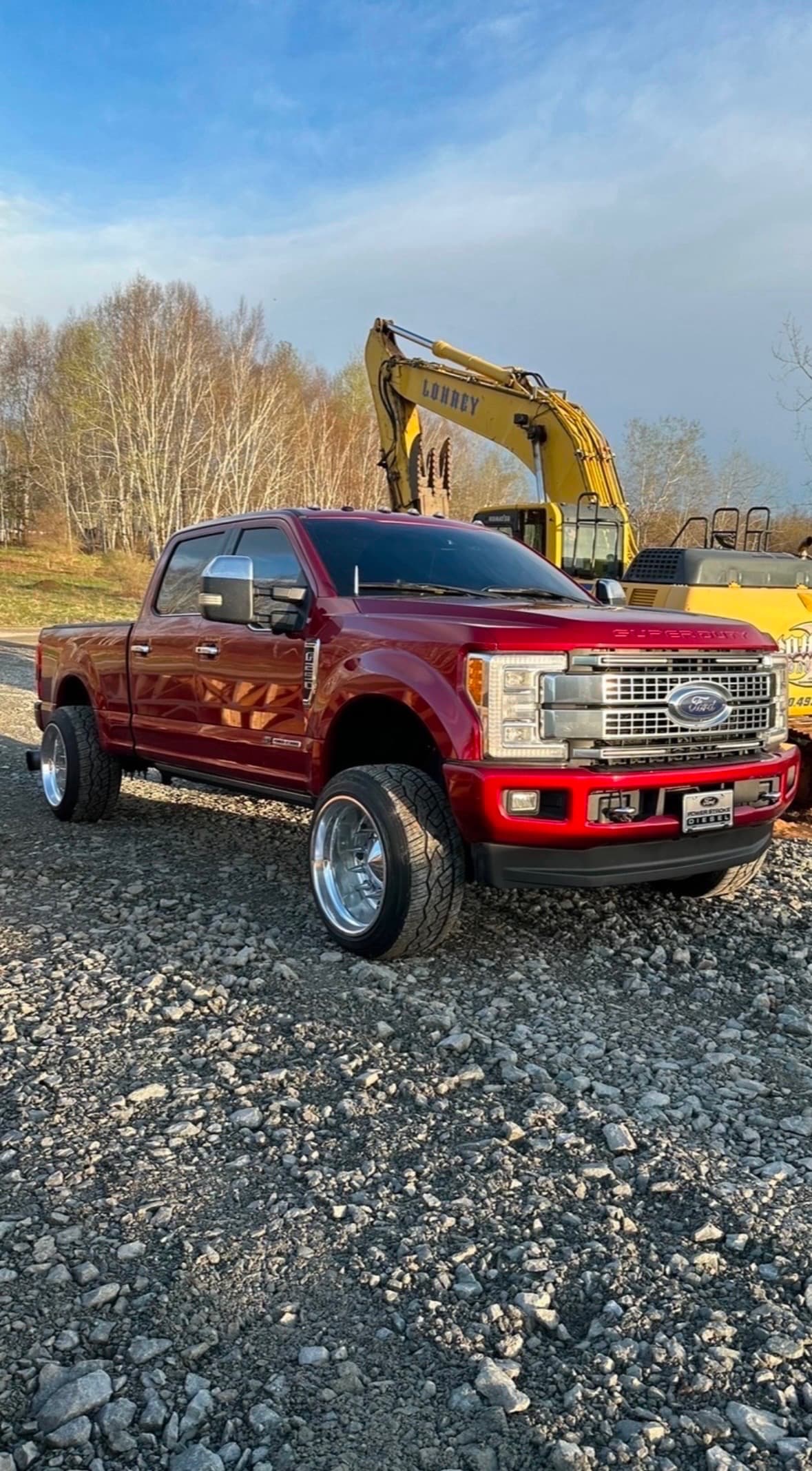 Diesel truck tuned by Fine Tuned Diesel parked beside heavy excavation equipment